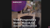 Pengendara Motor Masuk ke Minimarket